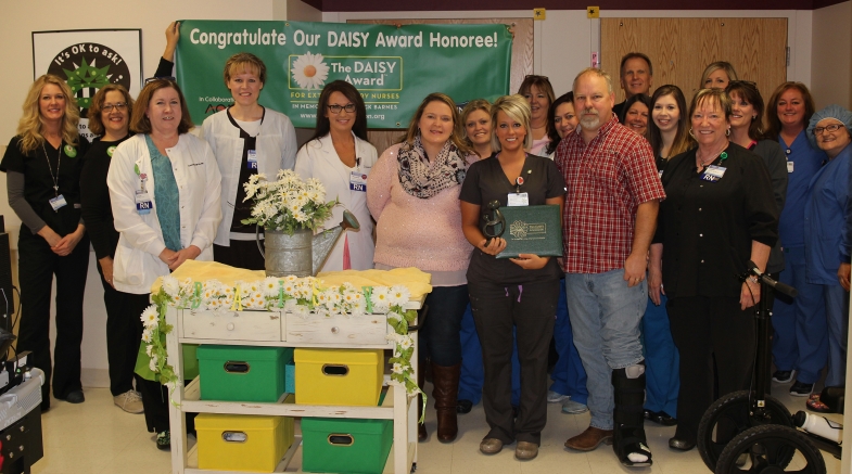 group of workers and DAISY award receiver 